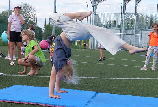 Children in athletic wear doing gymnastics at Studio 33