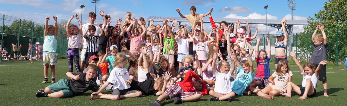 Children doing team exercise in colorful athletic wear